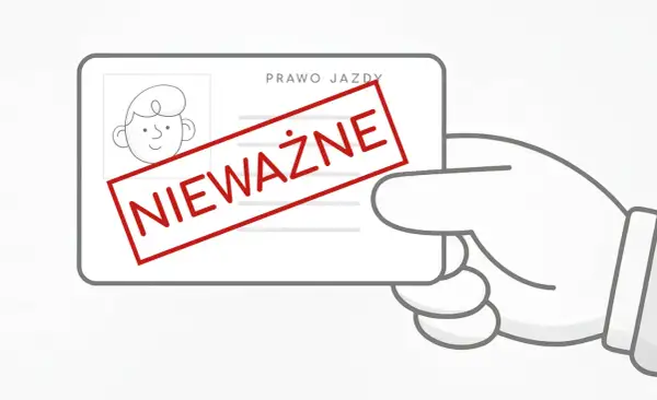 Ręka trzyma nieważne prawo jazdy. Taka sytuacja może skutkować mandatem za brak uprawnień do kierowania pojazdem.